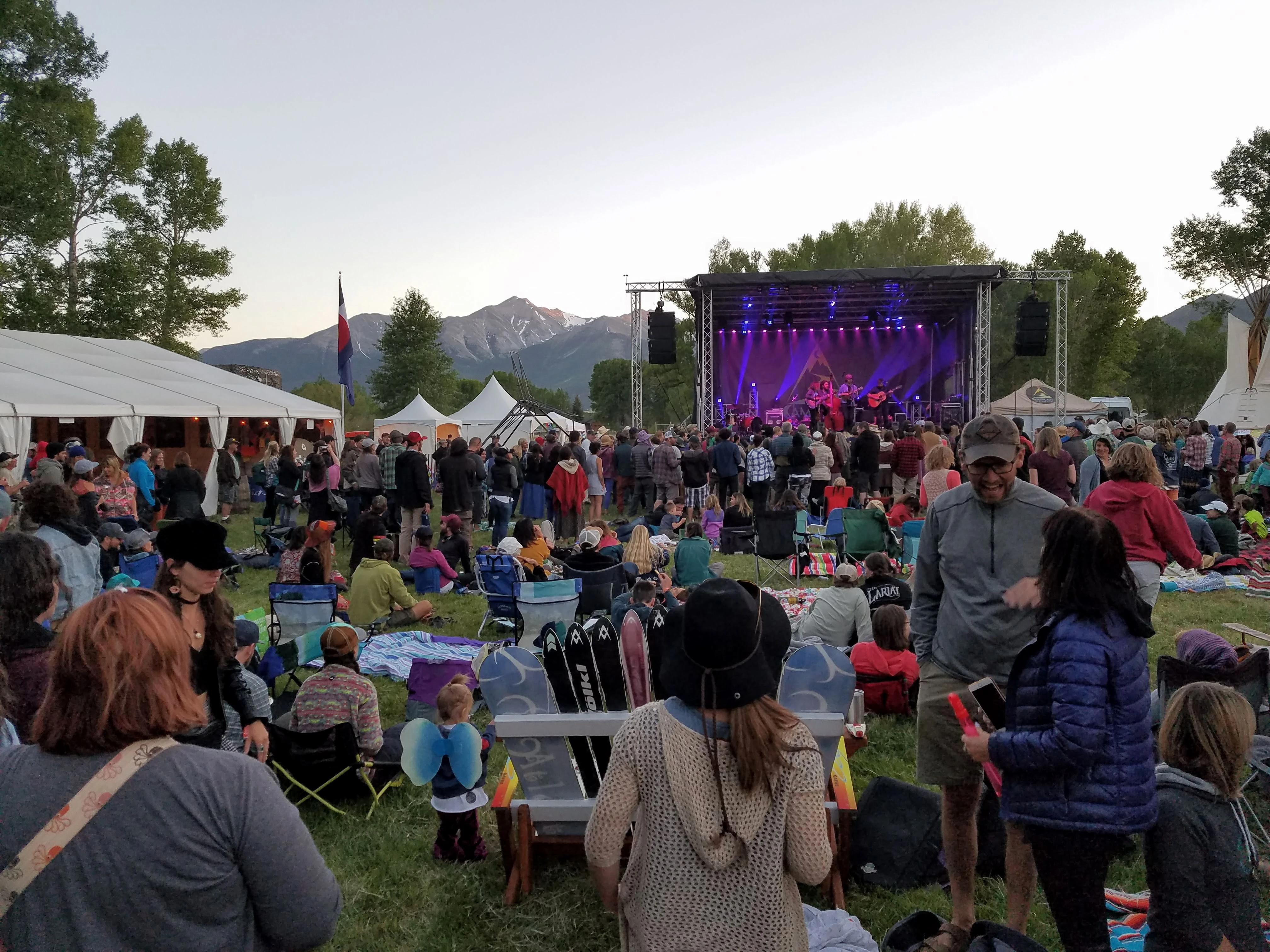 Community gathering at an outdoor festival in the mountains