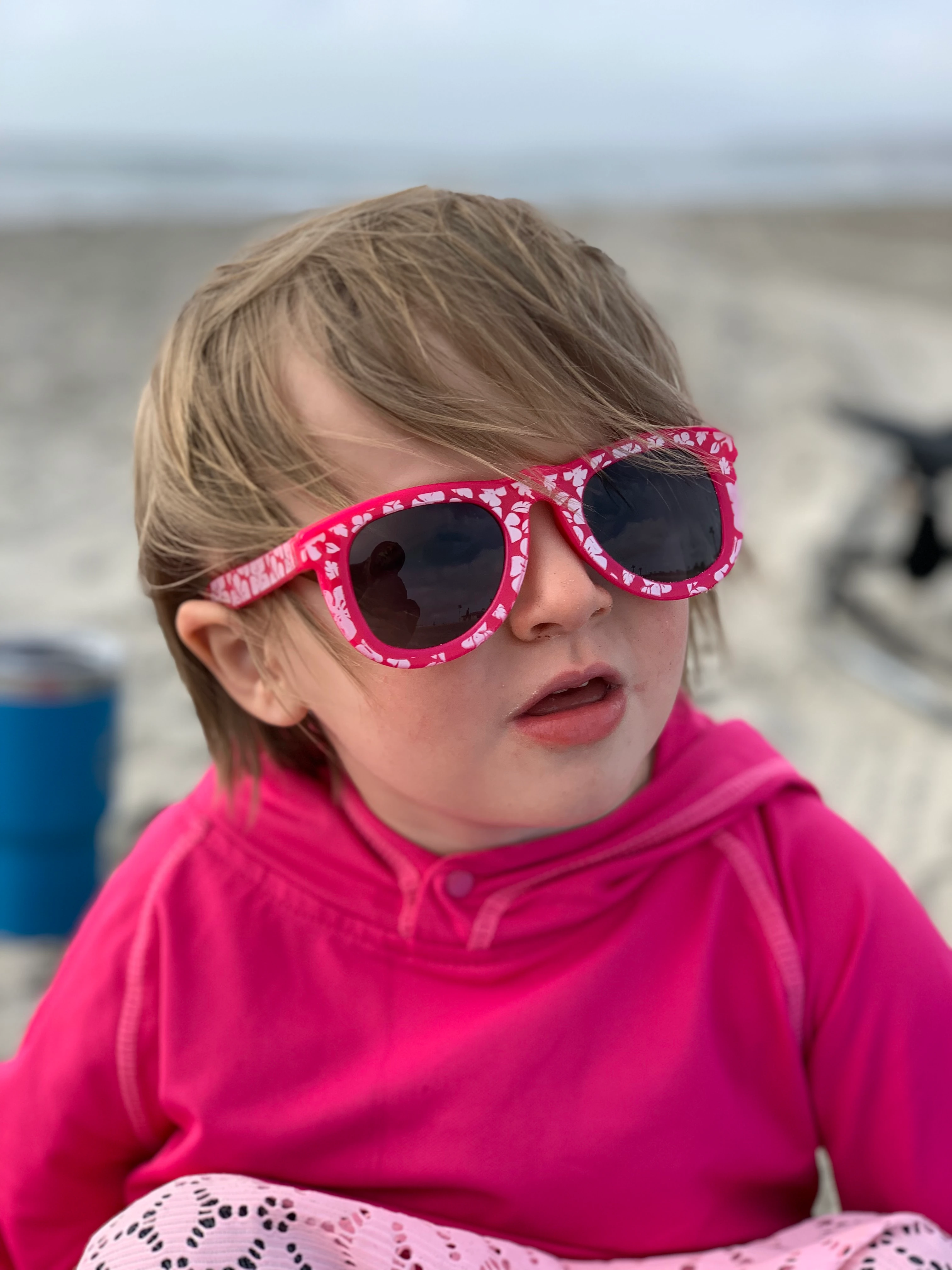 Emmy wearing pink sunglasses at the beach