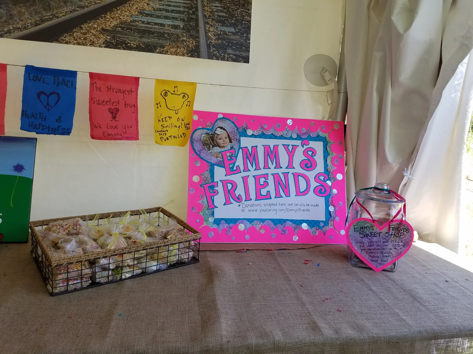 Handmade Emmy's Friends sign with prayer flags, Campout 2017