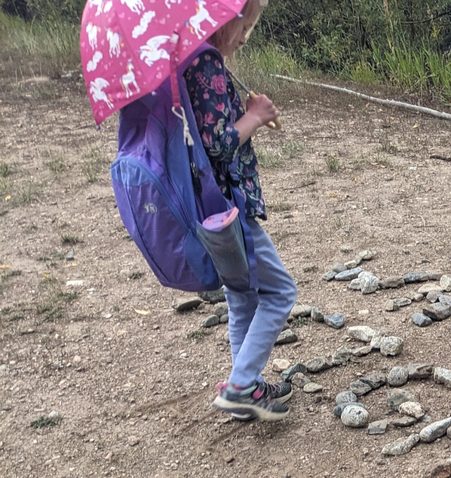 Emmy walking with an umbrella