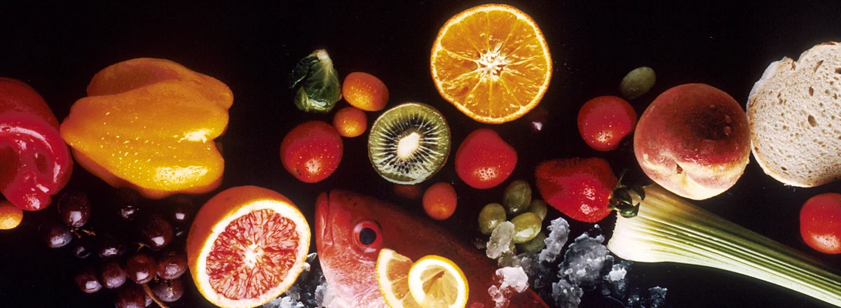 Colorful whole foods: fish, citrus, peppers, kiwi