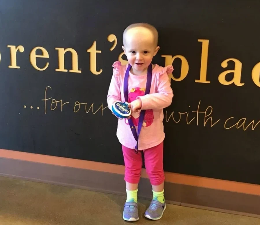 Emmy standing in front of the Brent's Place sign, May 2018