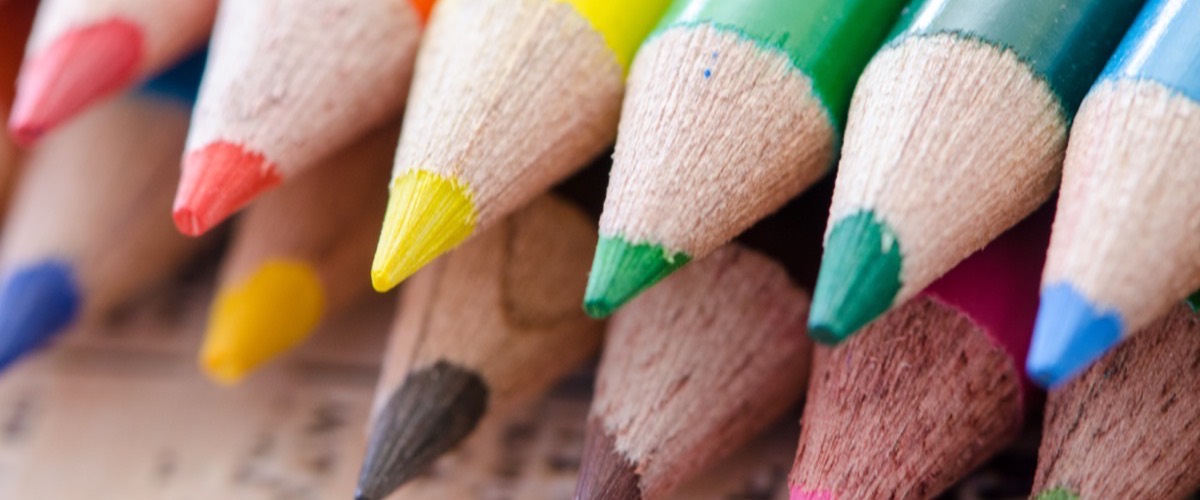 A row of brightly colored pencils