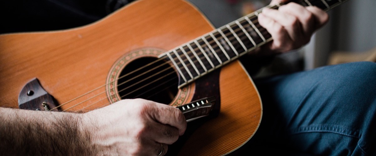Someone playing an acoustic guitar